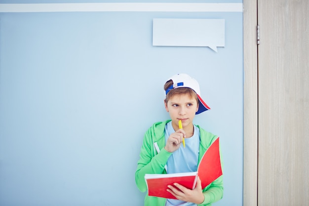 clever-kid-thinking-with-notebook_1098-654