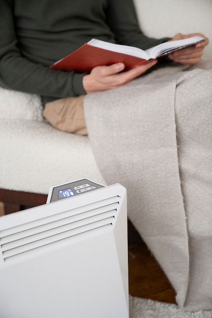close-up-person-near-heater_23-2149284098