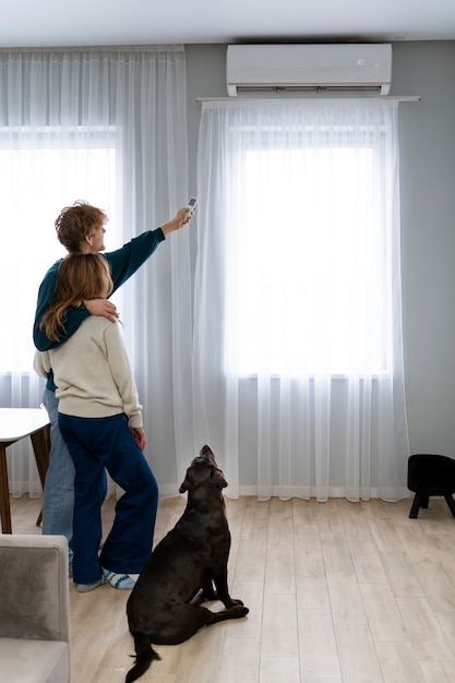 full-shot-couple-dog-home_23-2149335102