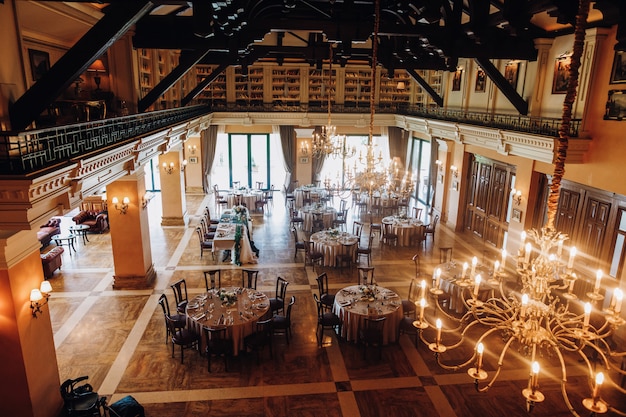 view-from-ceiling-decorated-celebration-hall-with-round-tables_8353-10198